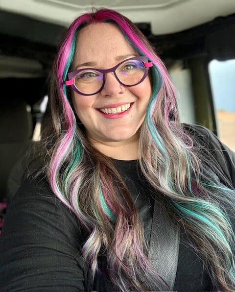 Heather Prather, a young lung cancer patient, smiles in her car