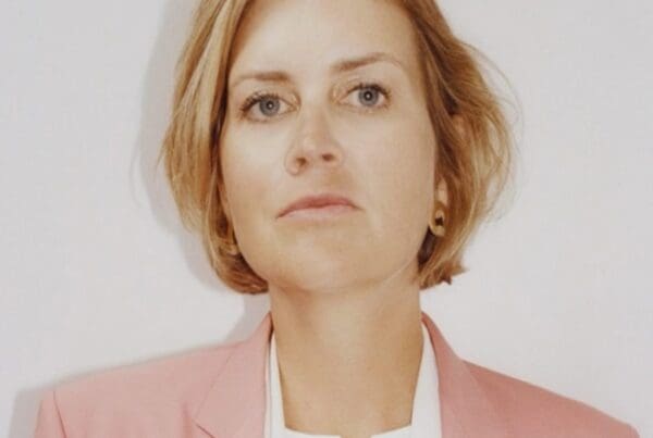 Jessie Creel was diagnosed in 2024 with stage IV EGFR NSCLC. She was 42 years old and had 3 young children. Jessie is a well know producer and director. She is wearing a white shirt and pink jacket with blond hair.