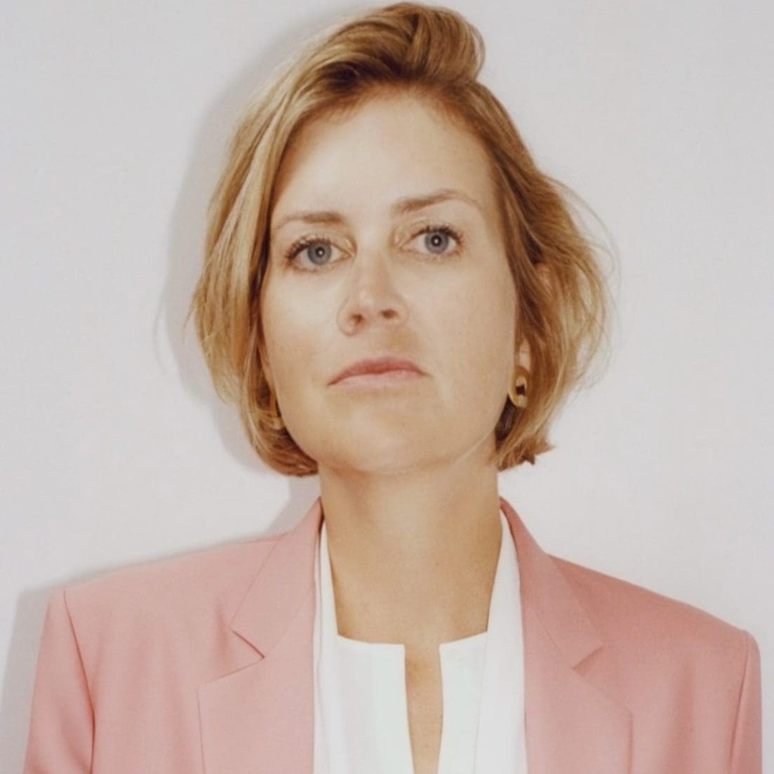 Jessie Creel was diagnosed in 2024 with stage IV EGFR NSCLC. She was 42 years old and had 3 young children. Jessie is a well know producer and director. She is wearing a white shirt and pink jacket with blond hair.