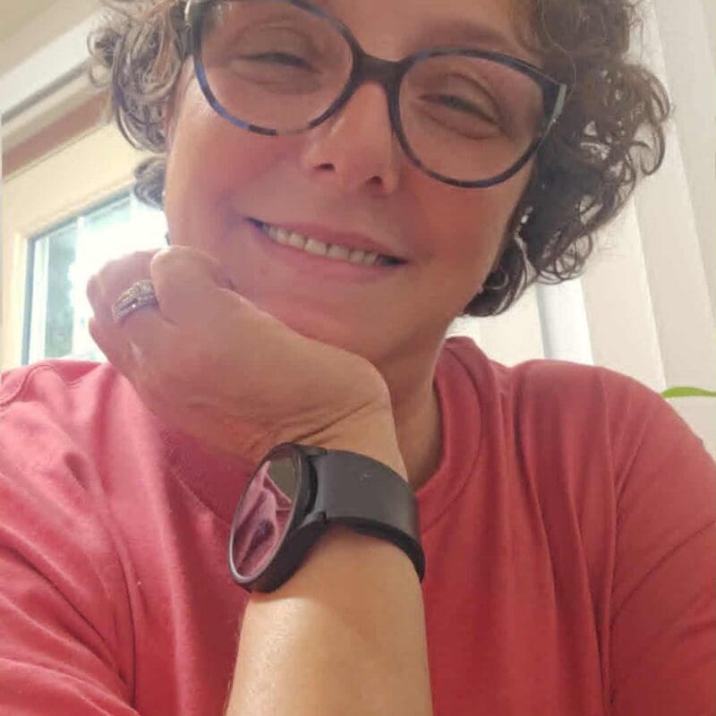 April, a young lung cancer patient, smiling wearing glasses