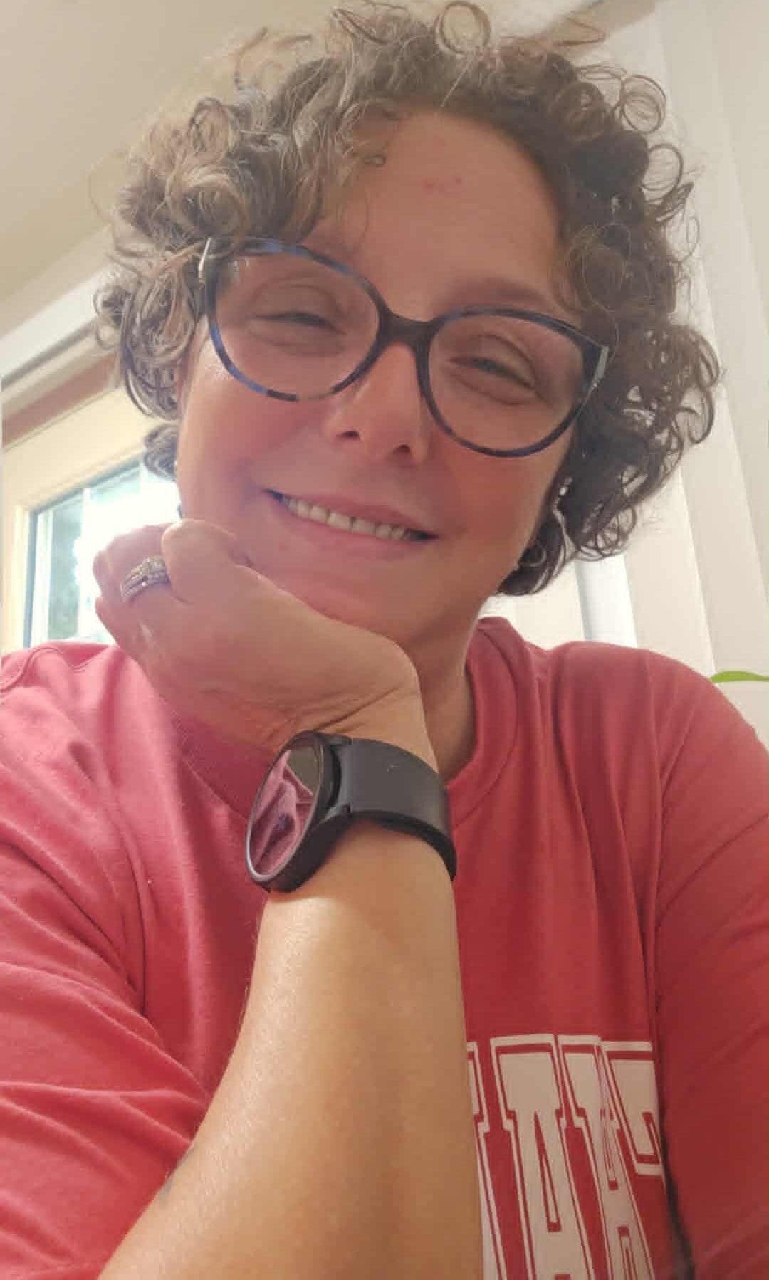April, a young lung cancer patient, smiling wearing glasses