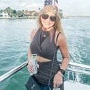 Lisa, a woman with lung cancer from Massachusetts smiles on a boat.