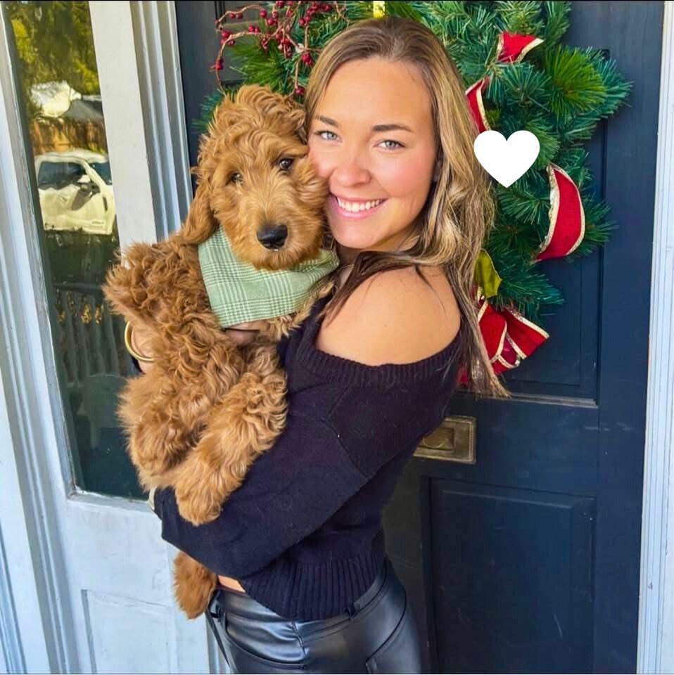 Maddy, a young woman with lung cancer holds her dog. In loving memory.