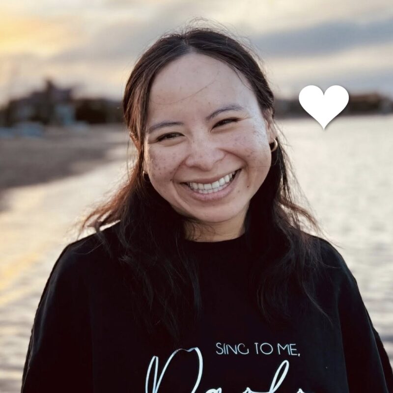 Anna, a young woman with lung cancer, smiles on the beach. In loving memory.