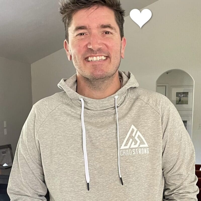 Chad Dunbar, young lung cancer patient, smiling in a gray hoodie