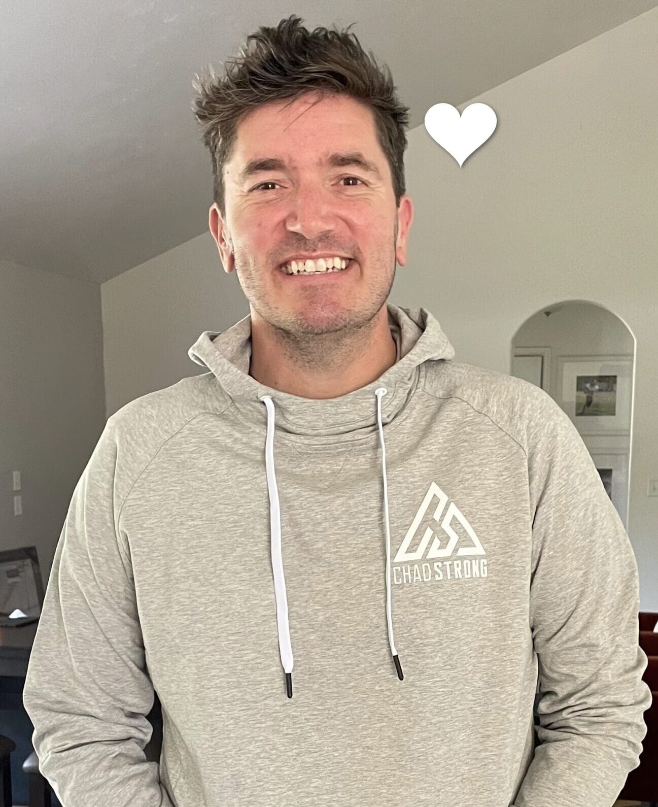 Chad Dunbar, young lung cancer patient, smiling in a gray hoodie