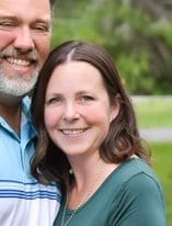 Lung cancer patient Denise poses with her husband outdoors