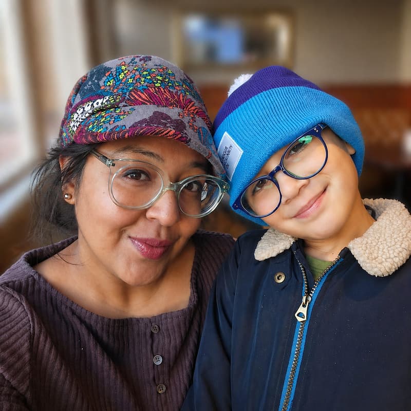 Hannah, a young lung cancer patient posing with her son