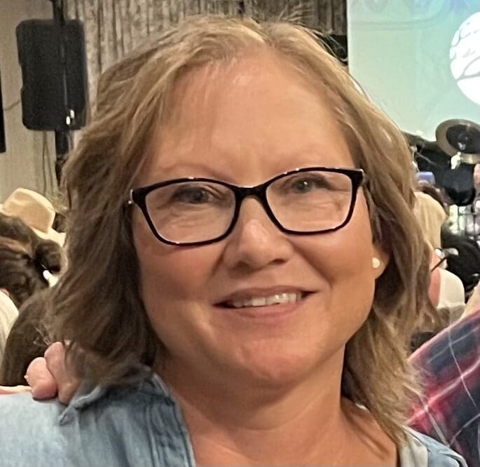 Tracy, a patient with young lung cancer, smiles at an event
