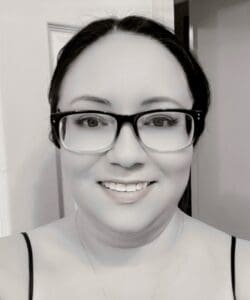 Jodi, young lung cancer patient smiles in a black and white photo