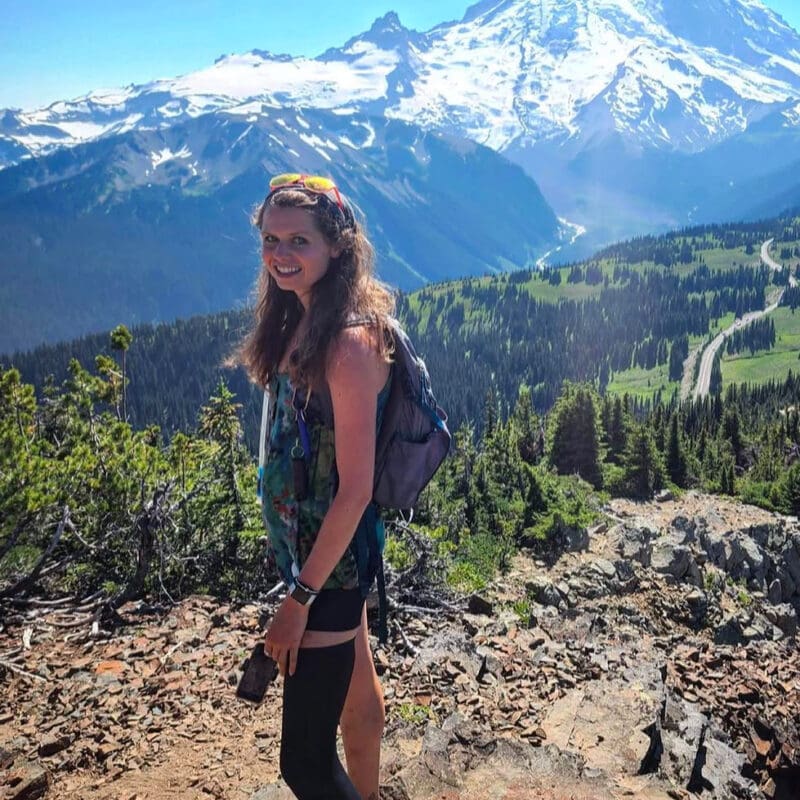 Lauren Coye, lung cancer advocate, hikes a mountain trail and smiles