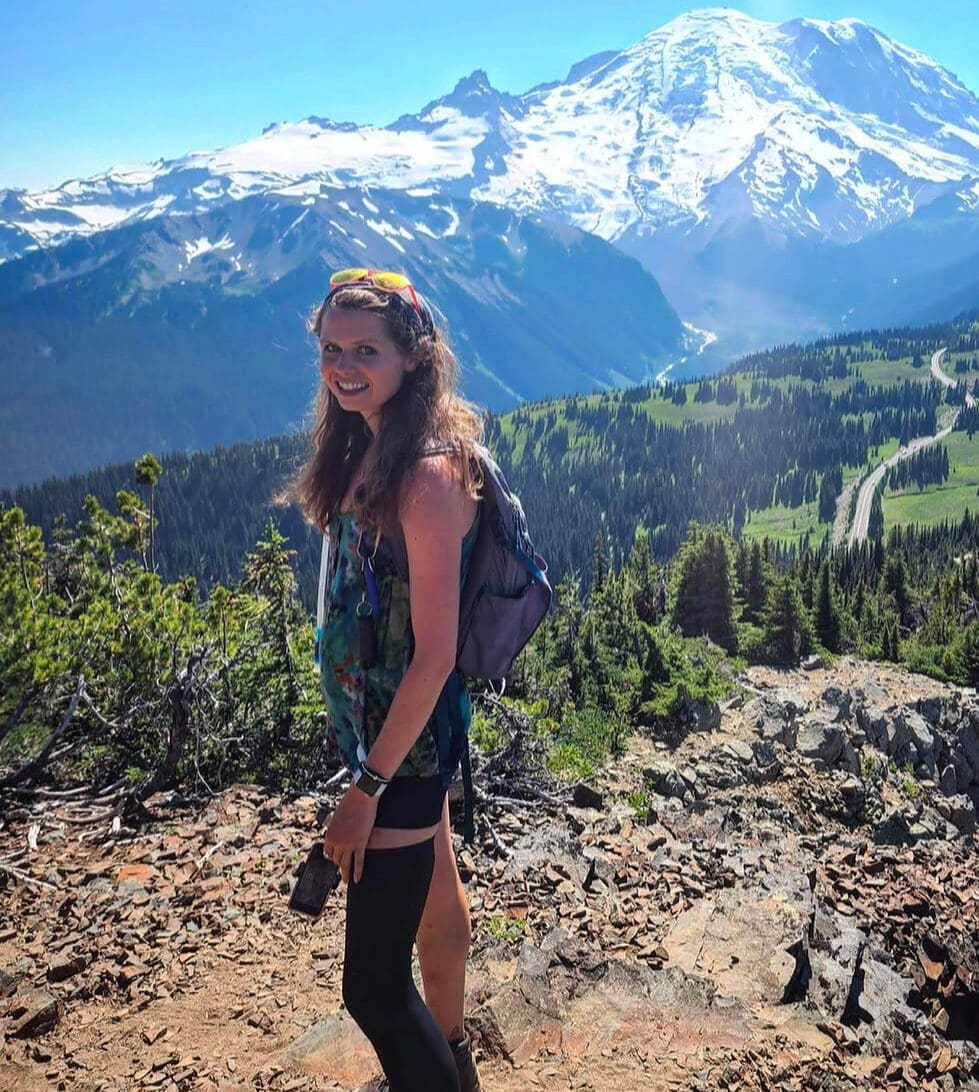 Lauren Coye, lung cancer advocate, hikes a mountain trail and smiles