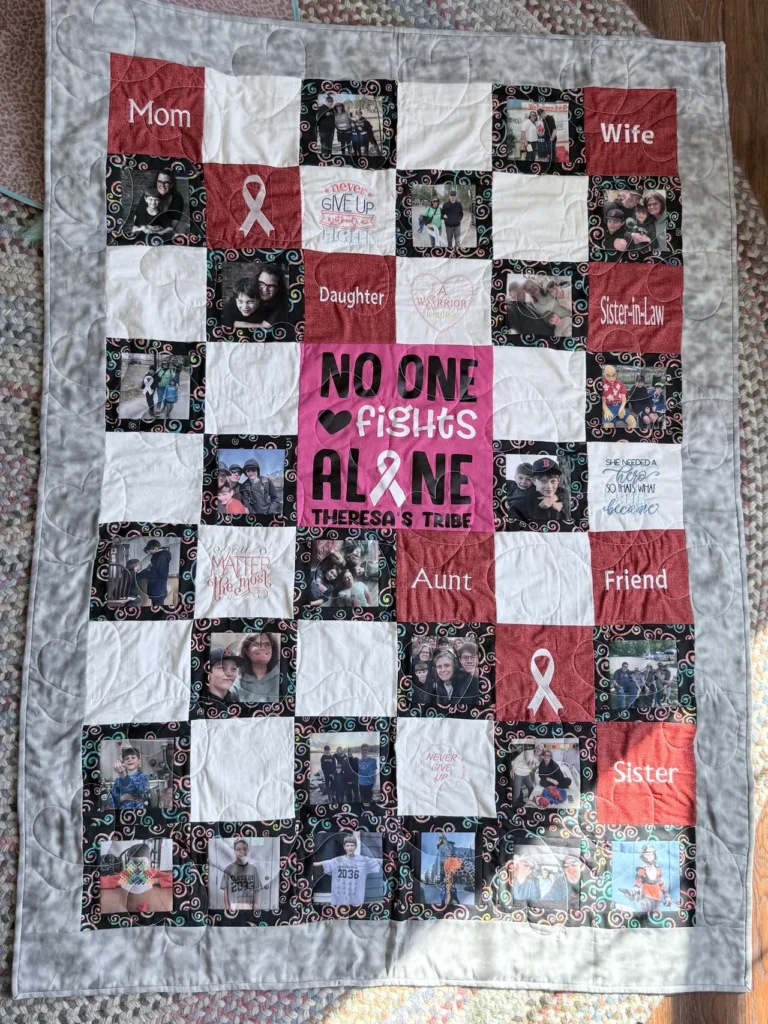 A memory quilt reading No One Fights Alone, made from photos and lung cancer ribbons