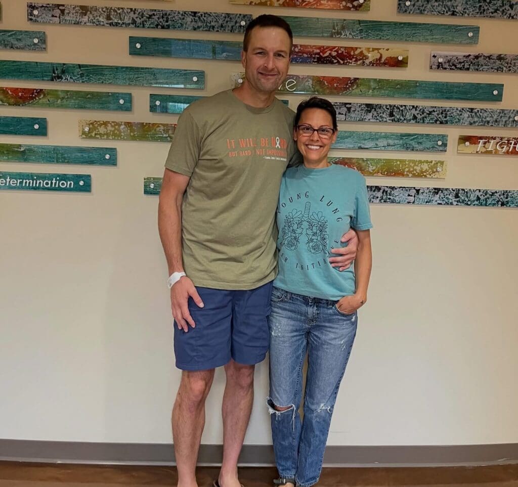 Bernie and his wife Kari smiling with their arms around each other, wearing Young Lung Cancer Initiative shirts
