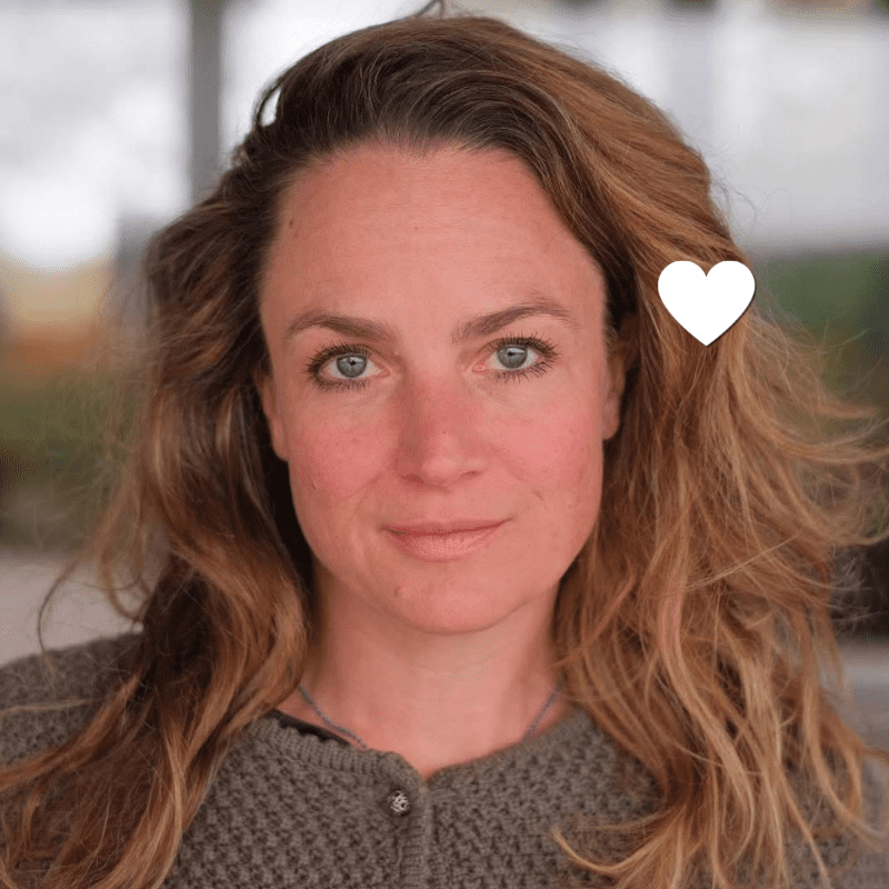 Portrait of Kathrin, smiling, with a white heart marking that she has passed away