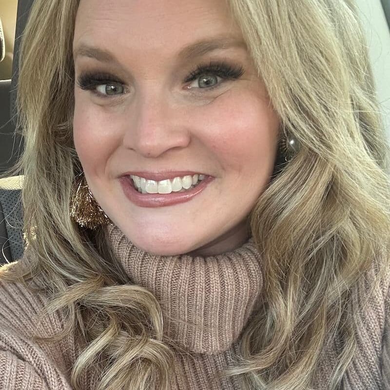 Crissy, a young lung cancer patient from South Carolina, smiling in a turtleneck