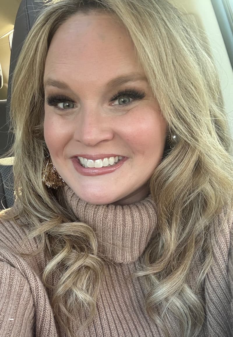 Crissy, a young lung cancer patient from South Carolina, smiling in a turtleneck