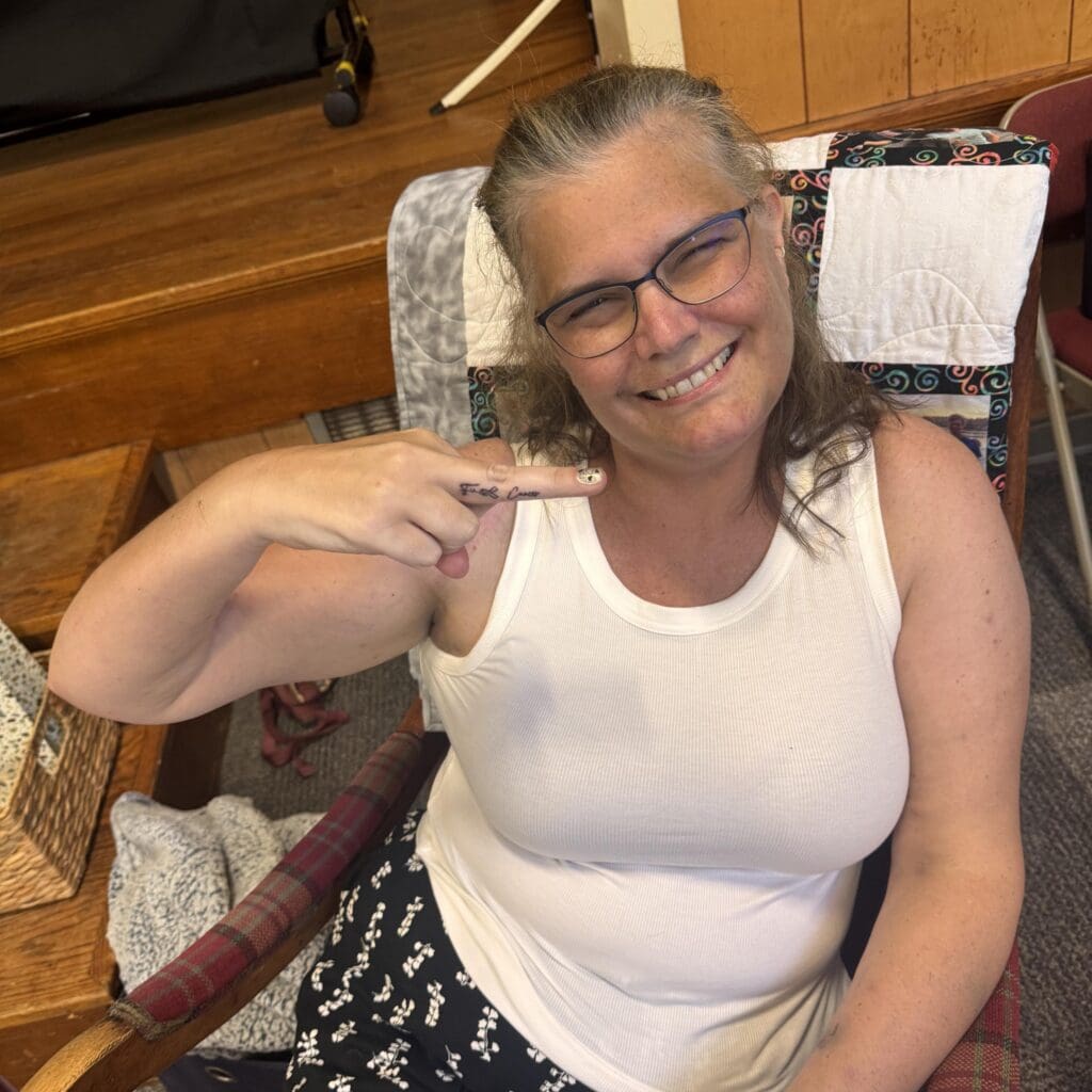 Theresa Woodbury shows off her “f cancer” tattoo at her Living Celebration of Life