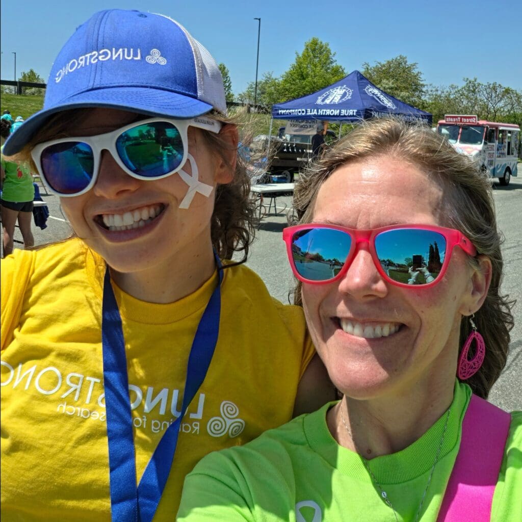 Two young lung cancer patients smile outdoors at Lung Force walk in MA