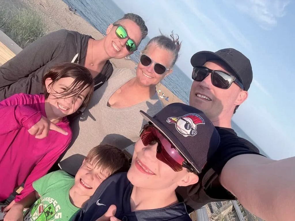 Theresa Woodbury smiling with family and friends