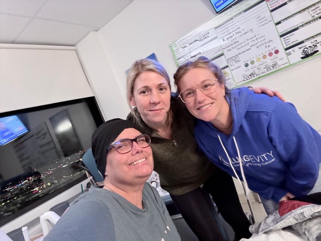 Theresa Woodbury and friends smile while Theresa is in the hospital