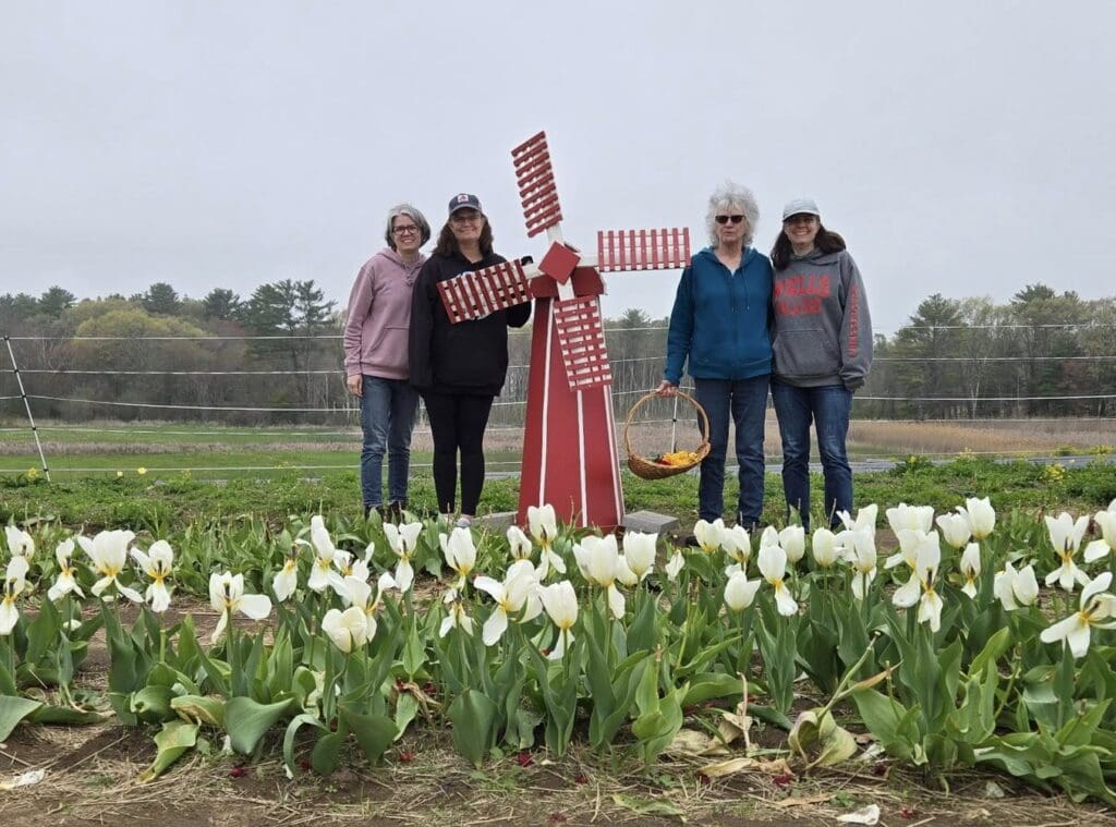Theresa Woodbury and family pose outdoors in flower field