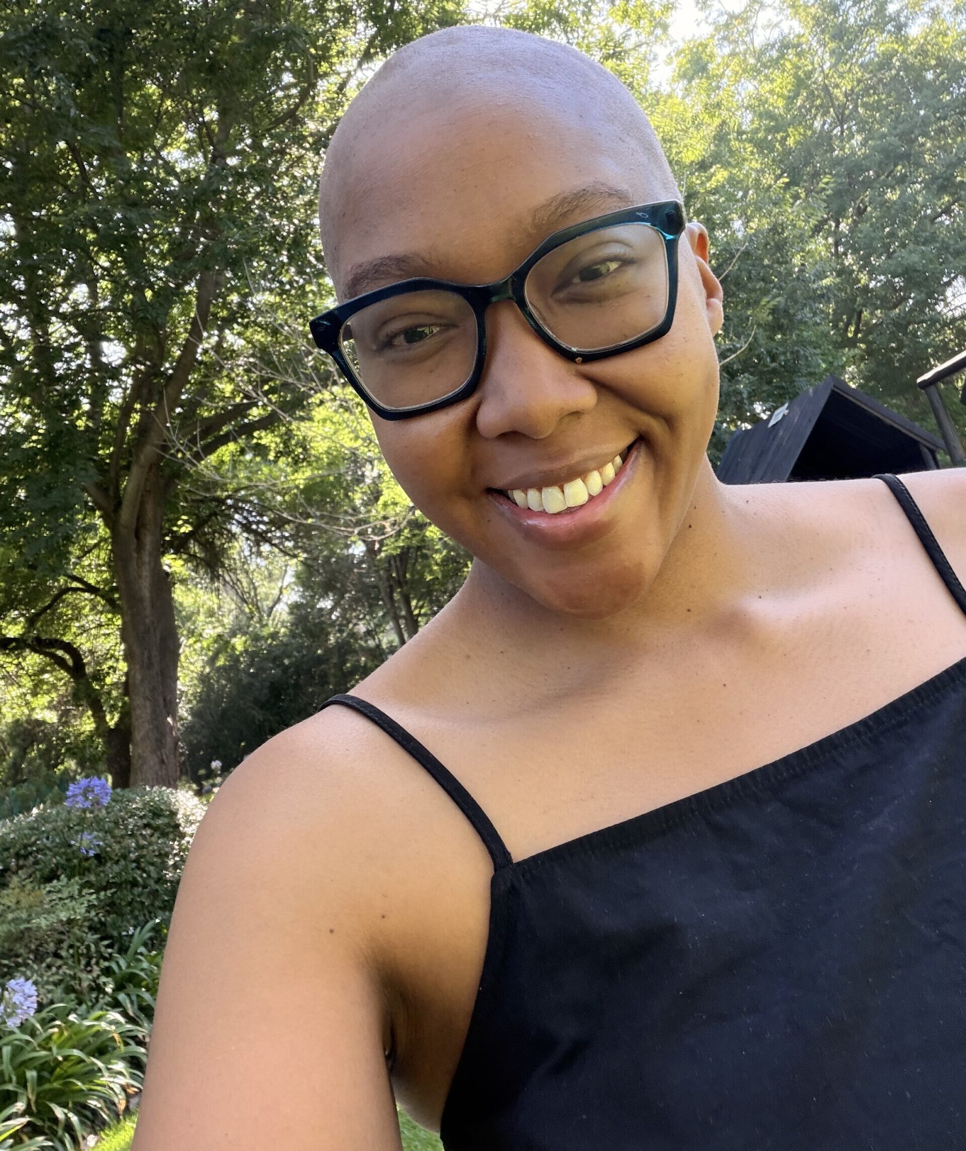 Young lung cancer patient, Cassidy Leslie, smiling out doors. From South Africa