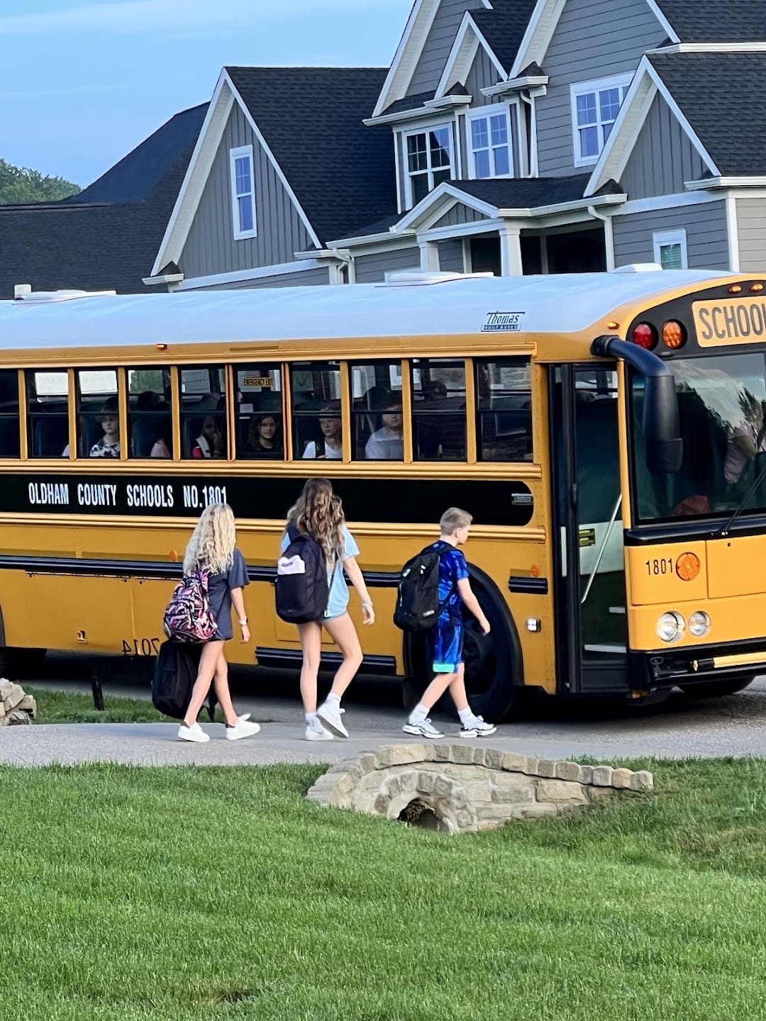 Leah’s children walking toward their yellow school bus