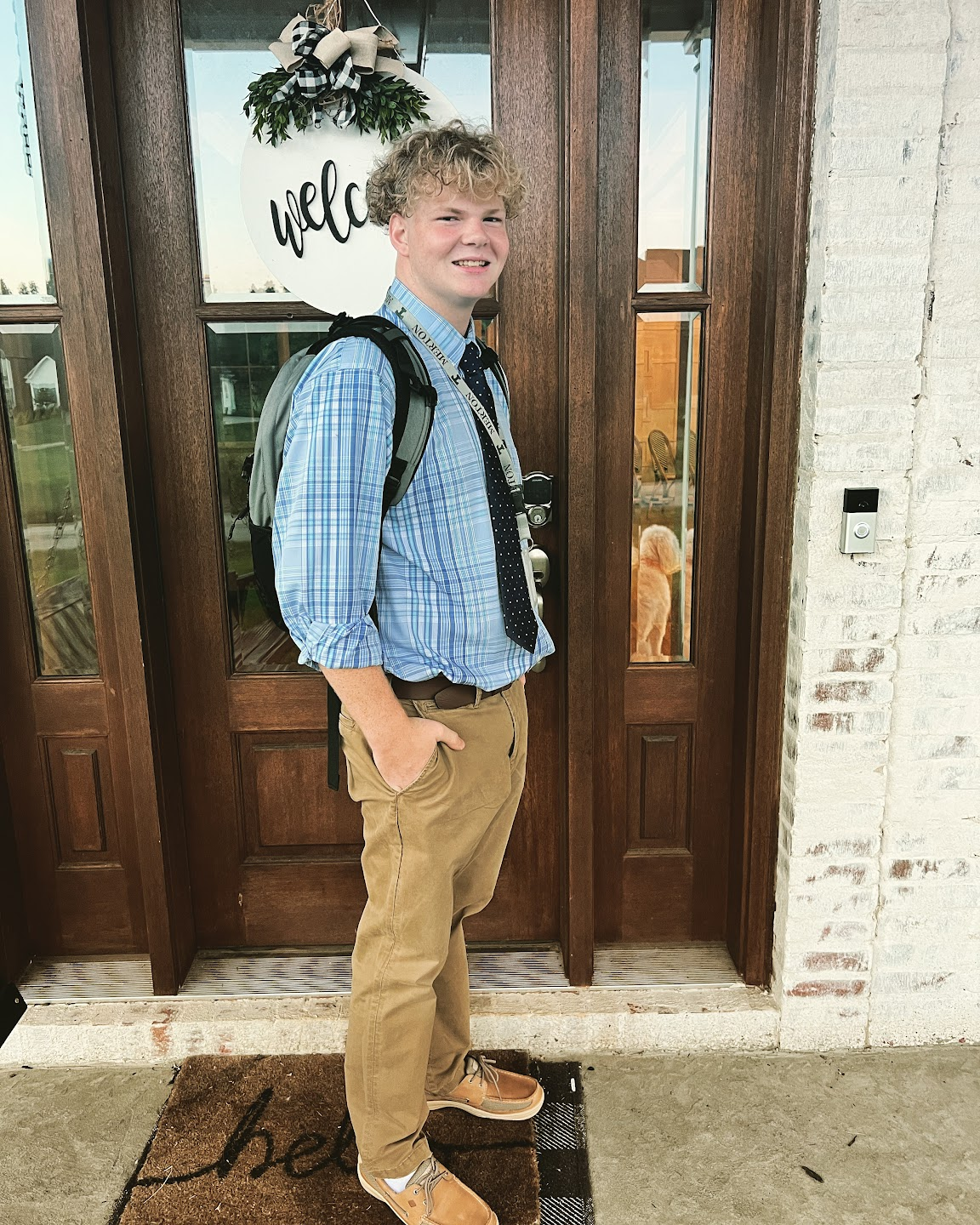 Leah’s oldest son dressed for school with his backpack outside the family home