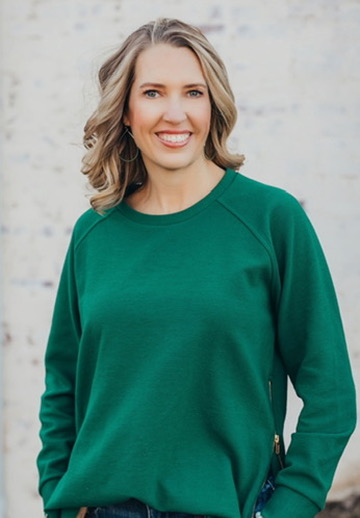 Portrait of Leah wearing a green sweater