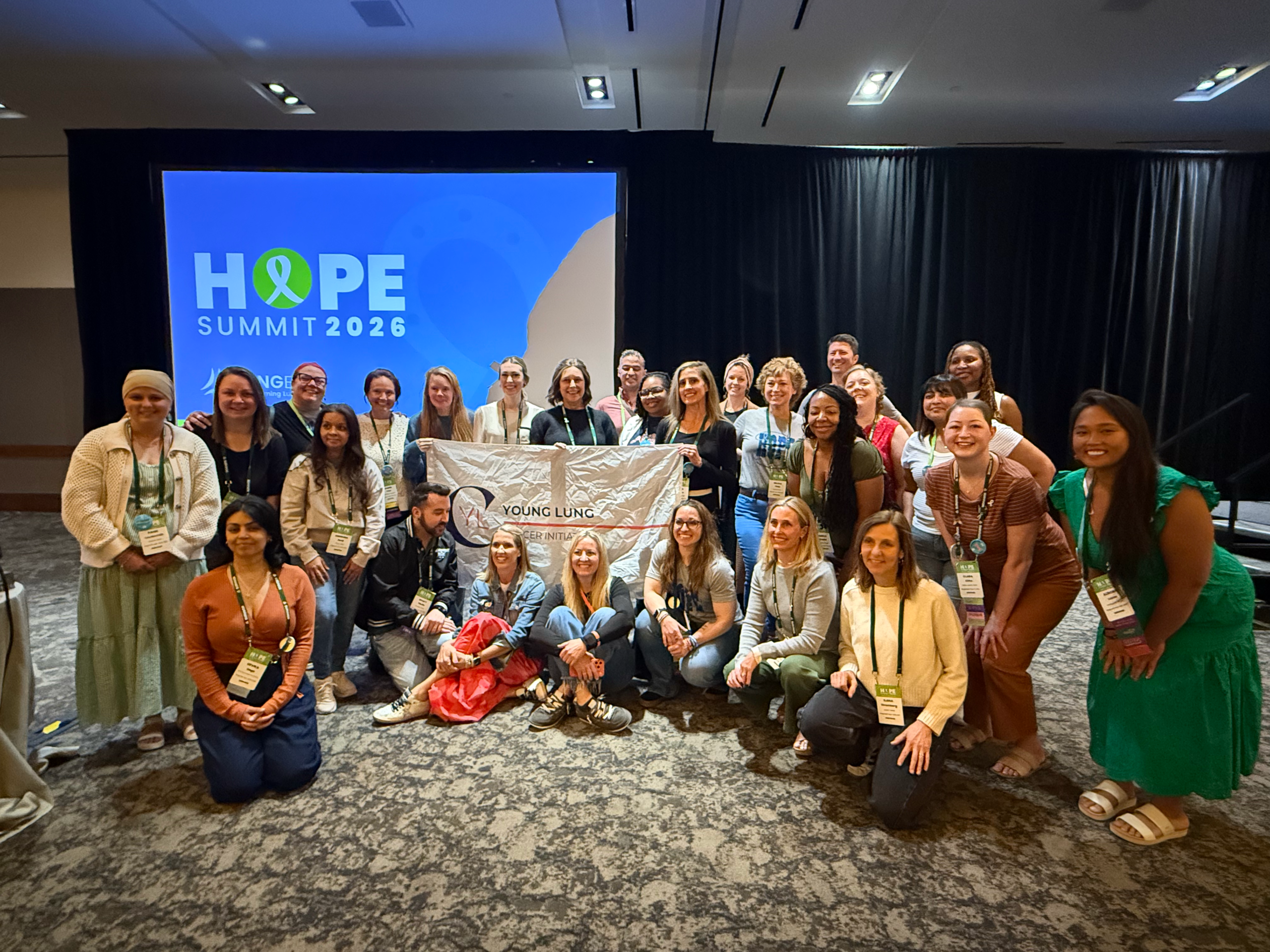 A group gathered with a Young Lung Cancer Initiative banner at HOPE Summit 2026.